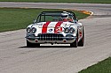 1960s Racing corvette on track, vintage Chevrolet Corvette at speed.