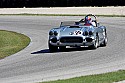 Racing silver roadster Chevrolet Corvette at speed.
