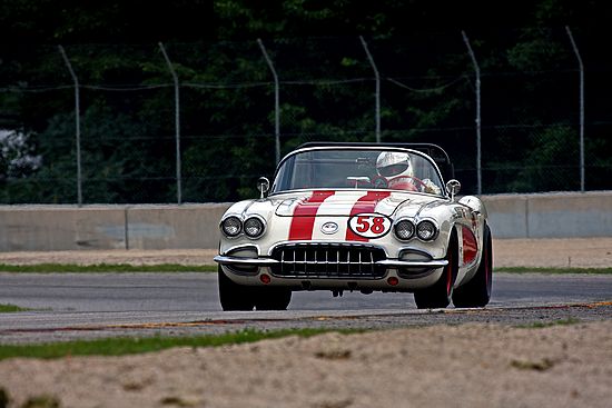 Front view, classic White and Red vintage Chevrolet Corvette at speed.