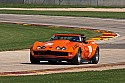 Orange roadster Chevrolet Corvette at speed.